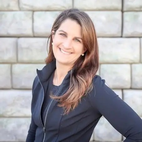Dr. Jenna Smith, smiling, wearing a dark jacket